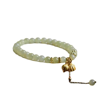 Natural Hetian jade bracelet with 6mm beads, engraved fu character, and constellation design on a simple string.