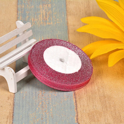 Close-up of green onion patterned ribbon with gold wire on a 25-yard roll, showing 3-points width.