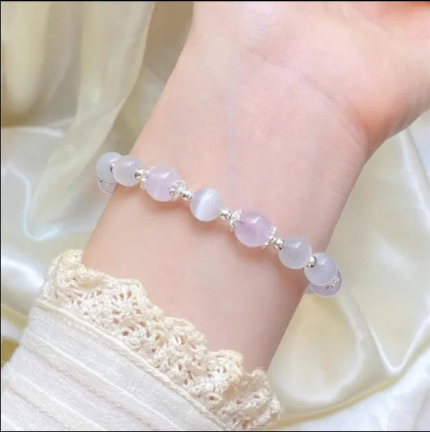 Moon-shaped women's bracelet with large opal amethyst crystal beads on wrist.