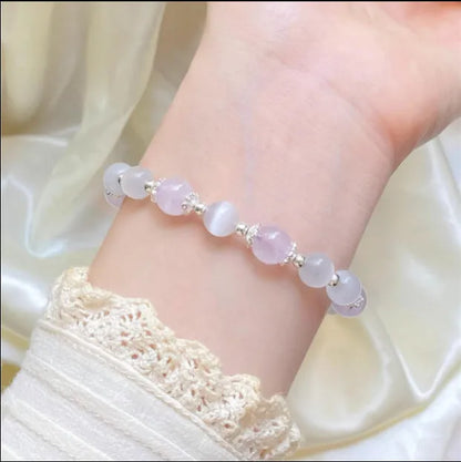 Moon-shaped women's bracelet with large opal amethyst crystal beads on wrist.