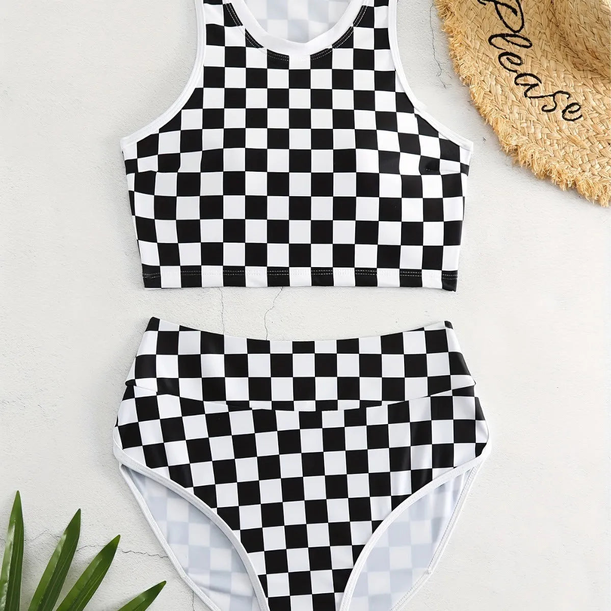 Women's checkerboard print backless one-piece swimsuit with suspender straps for swimming.