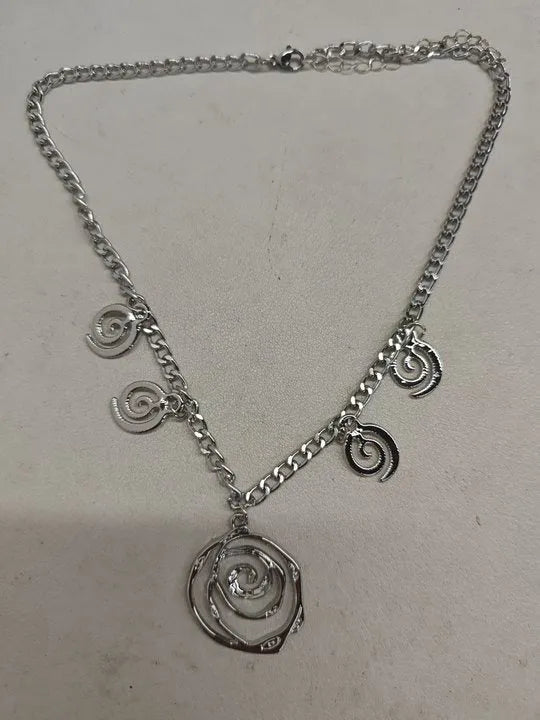 Gold spiral donut alloy jewellery set showing adjustable necklace, matching bracelet, and ear hooks on a plain background.