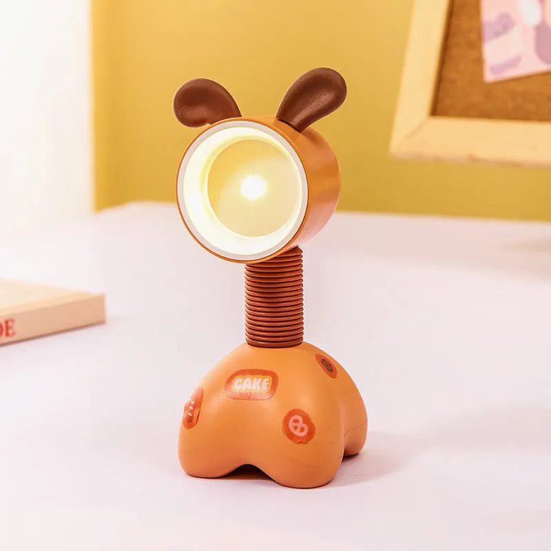 Colourful cartoon character magnetic DIY night light on a desk with adjustable head.