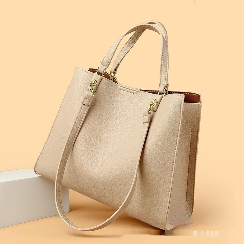 Women's messenger tote bag in horizontal square shape with crossbody strap and internal compartments