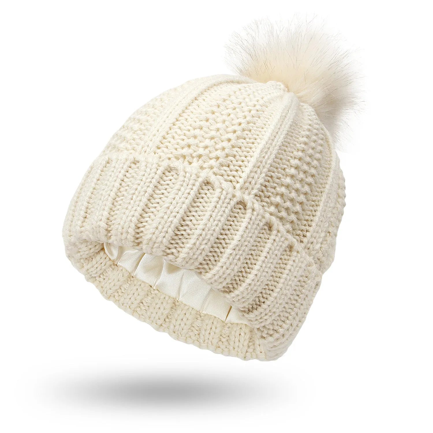 Woman wearing a wine red wool beanie hat with a faux fur pom pom and satin lining.