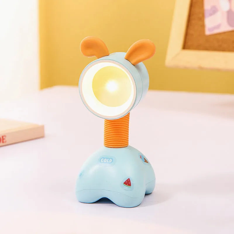 Colourful cartoon character magnetic DIY night light on a desk with adjustable head.