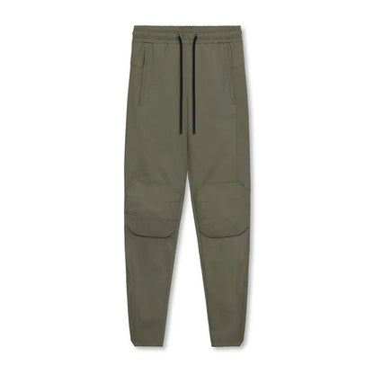 Men's grey fitness trousers with ankle ties, made from 100% polyester for quick-drying during exercise