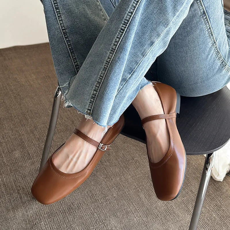 Women's sheepskin Mary Jane flat shoes in brown, showing round toe and low heel.