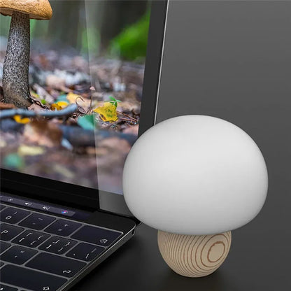 White silicone mushroom-shaped LED night light with a wooden base and touch control.