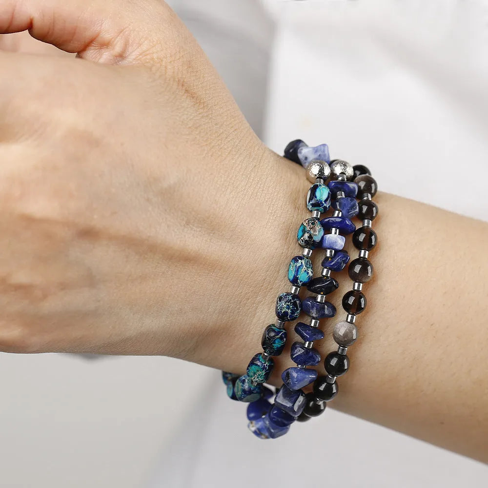 Hand-woven women's bracelet with crushed fang hui stone and gold obsidian geometric beads in multi-layer design