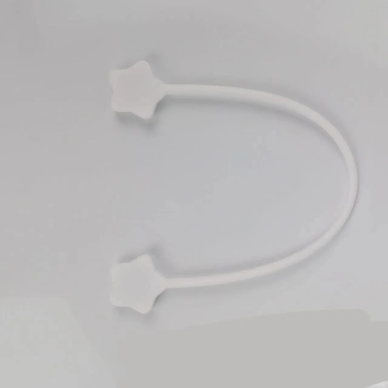 Silicone magnet wire winder for cable organisation in assorted colours on a white background.