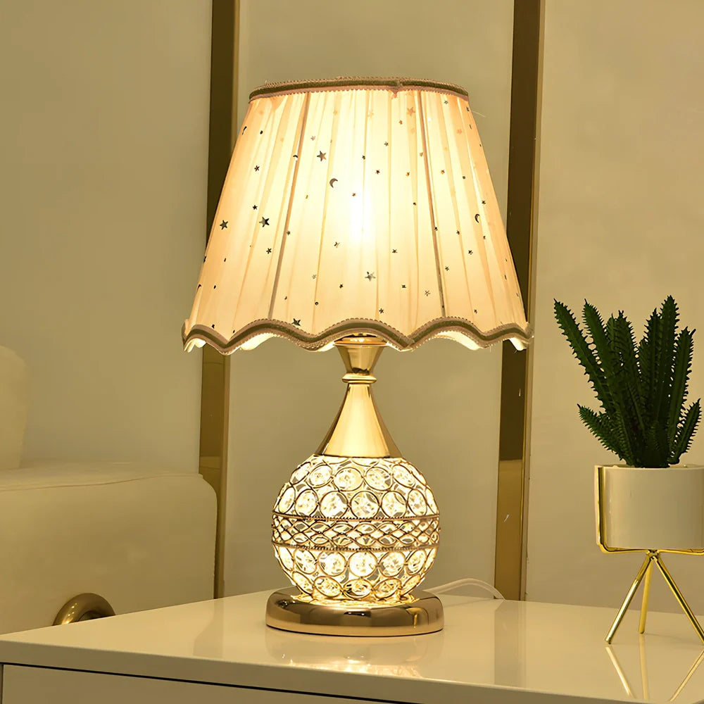 Gold crystal desk lamp with hand-cut facets and remote control on wooden surface