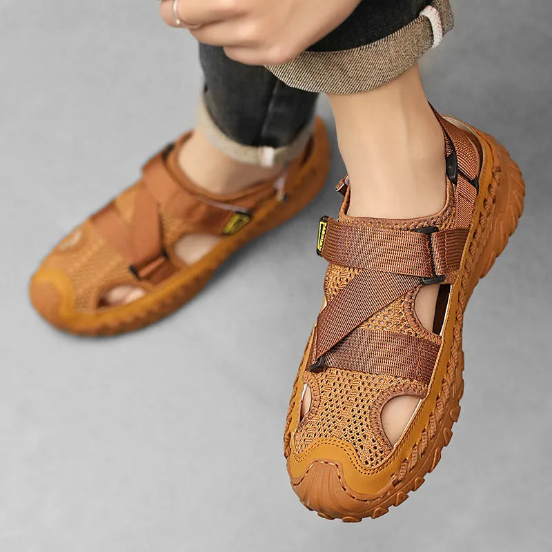 Men's gray casual sandals with mesh panels, leather upper, elastic strap, and rubber sole.