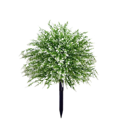 White artificial lavender plant with green leaves, a plastic floor decoration for home or events.