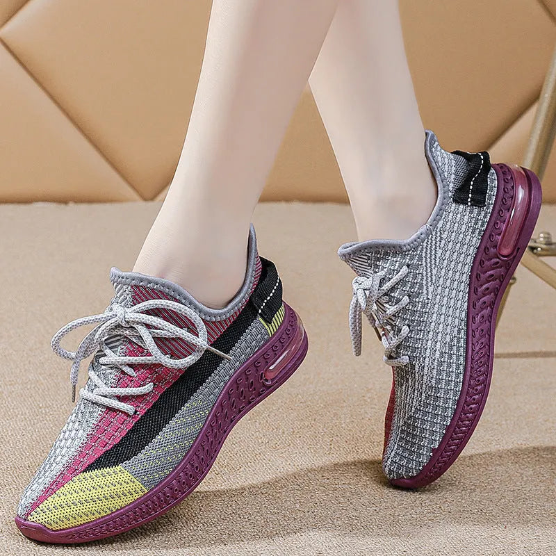 Women's casual running shoes in purple, black, and orange colours with fabric lining and plastic sole