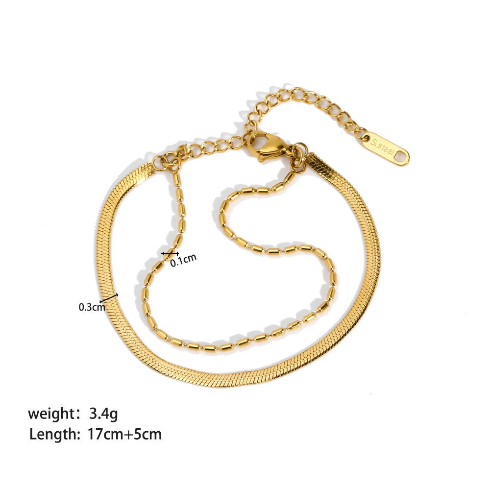 Elegant stainless steel bracelet with a sleek geometric design, gold-plated finish, and unisex style suitable for any occasion.