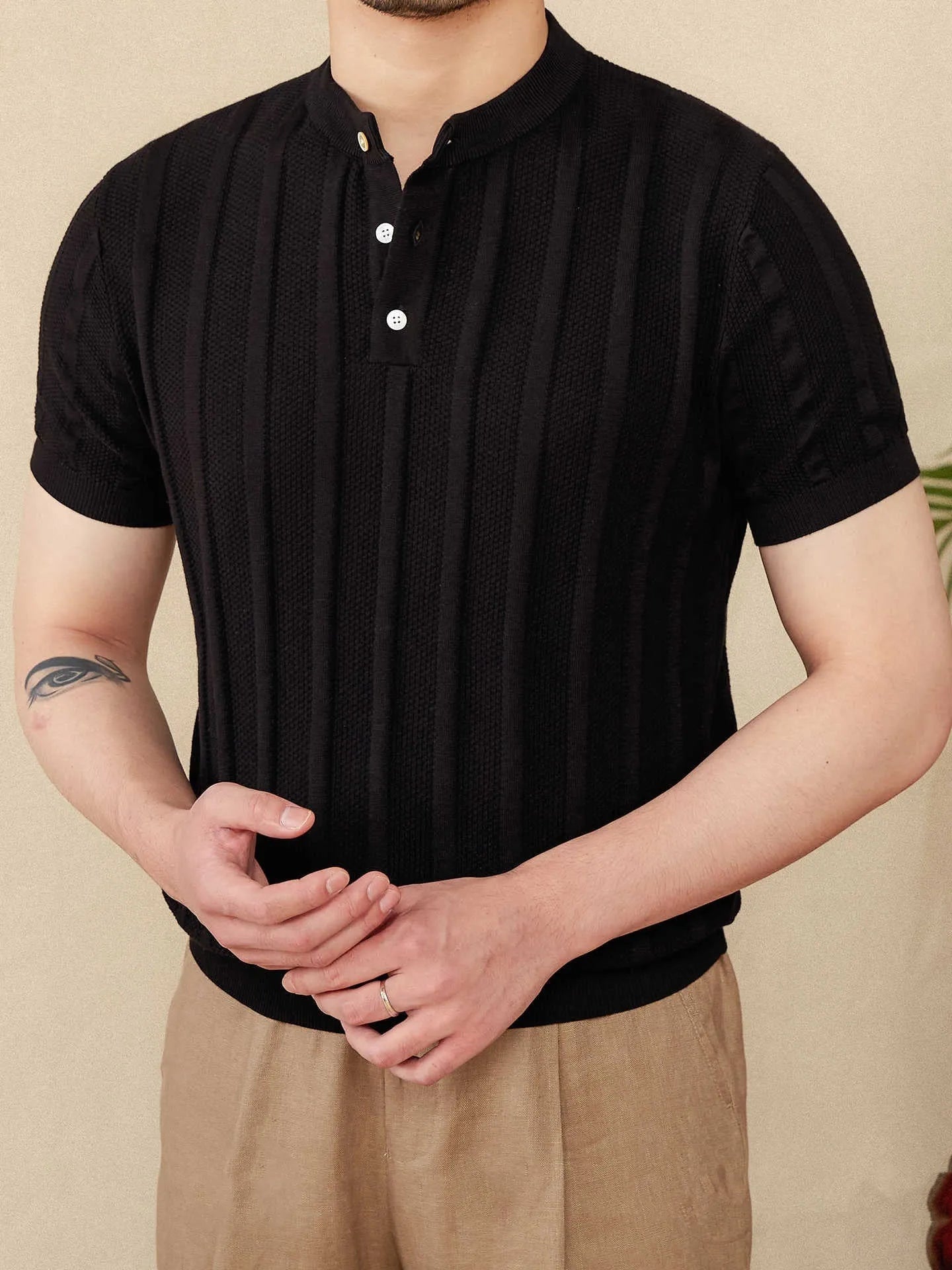 Men's creamy-white cotton T-shirt with a Henry collar and subtle sunken stripe pattern on the chest.