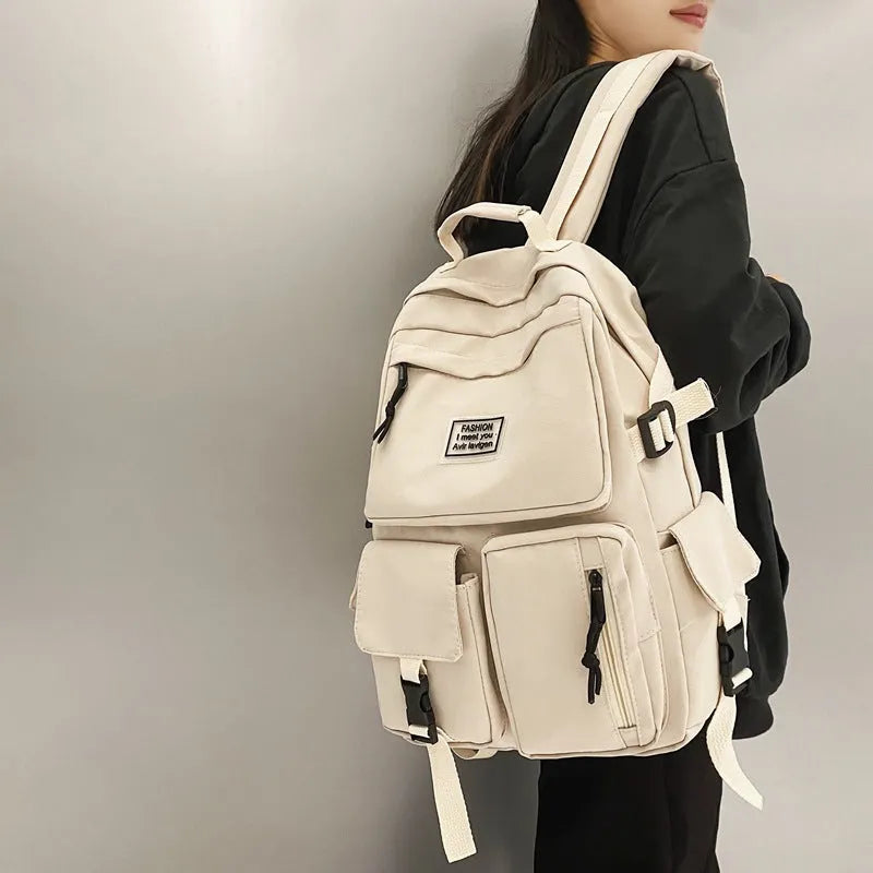 Black and white nylon student backpack with laptop compartment and three-dimensional pocket.