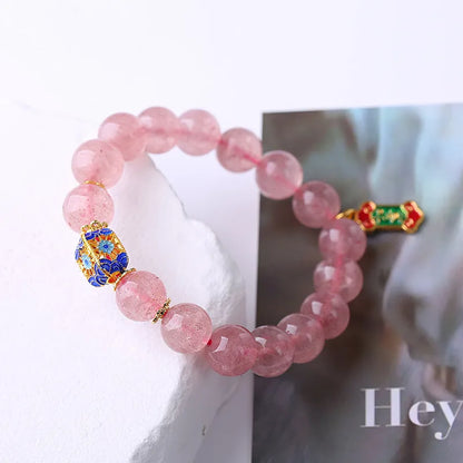 Pink crystal bracelet with Strawberry Quartz stones and Ruyi charm in hand-woven women's jewellery design