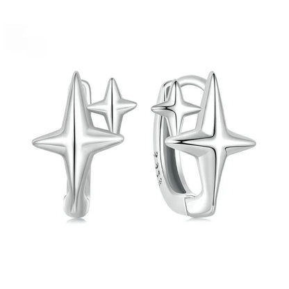 Sterling silver minimalist star ear clip with oxidised finish and XINGX design detail.