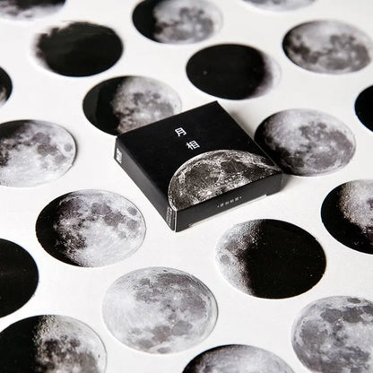 Box containing 45 black moon phases and calendar planet decorative stickers on self-adhesive paper.