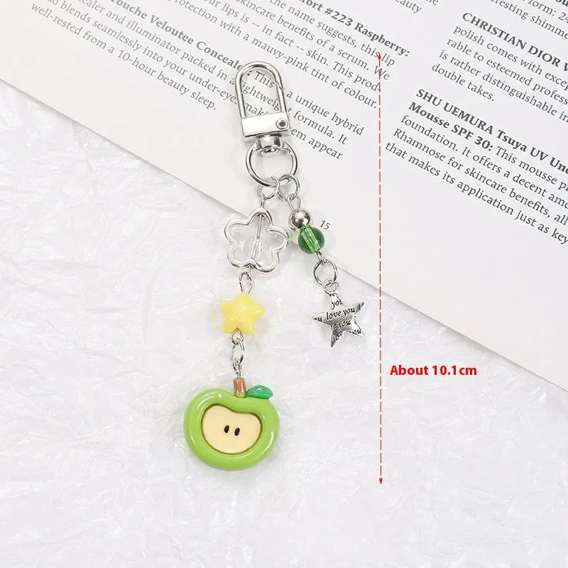 Plastic and resin fruit charm keychain with apple, strawberry designs on silver rope