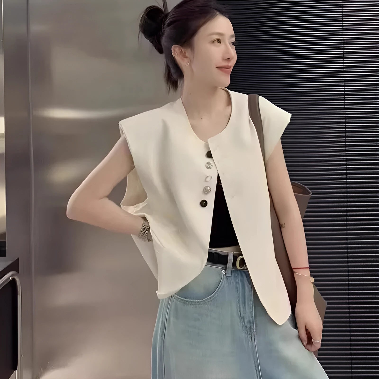 Beige loose-fit women's waistcoat with pockets on a hanger, showing short 40cm length and V-neck design.