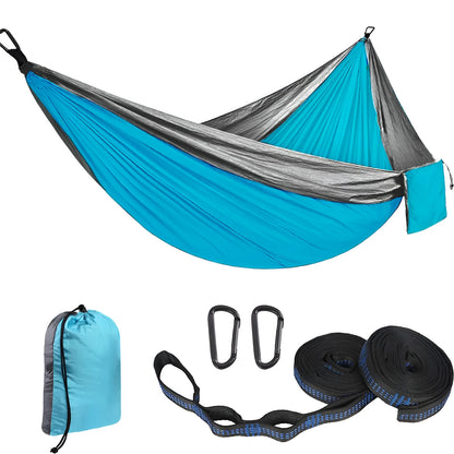 Parachute cloth double camping hammock in chosen colour, with black buckles and round ropes on a tree.