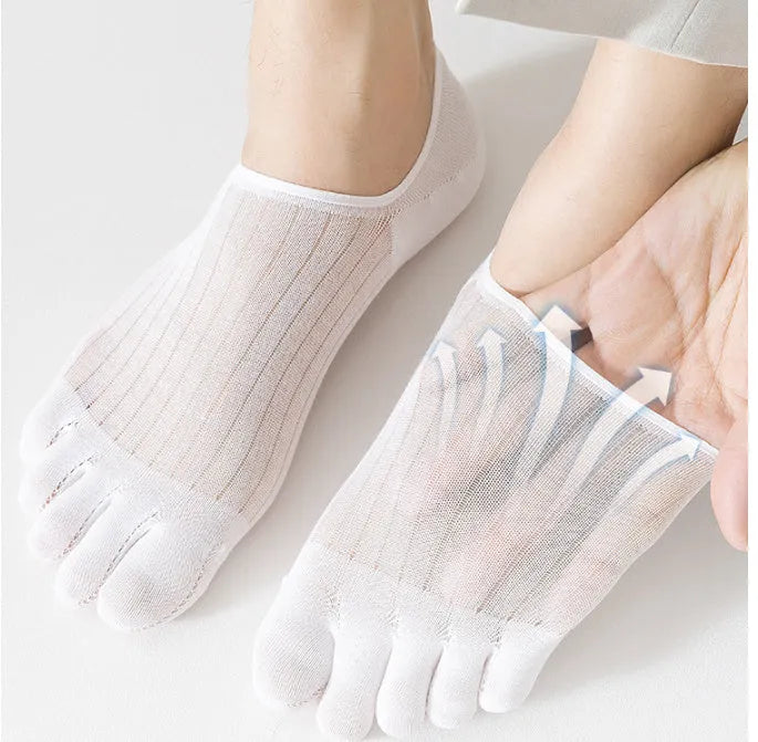 Pair of solid colour modal five-finger invisible socks on a wooden surface, showing toe separation and low-cut design.