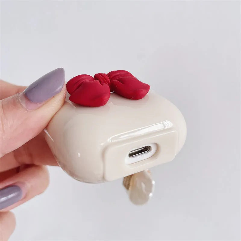 Beige red bow shell patterned TPU clamshell protective case for AirPods Pro earphones.