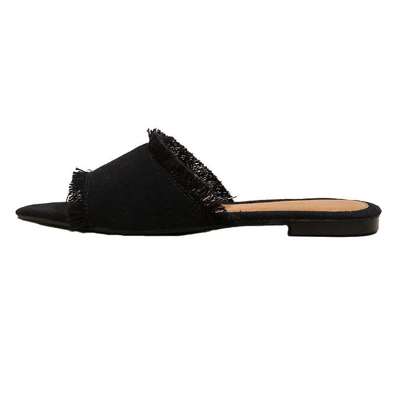 Women's denim casual flat slippers with tassel detail, available in apricot, black, green, blue, royal blue, grey and wine red colours in UK sizes 35-43, featuring a lightweight PVC sole and leather lining for leisure wear