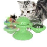 Cat playing with rotating windmill toy featuring luminous balls and suction base