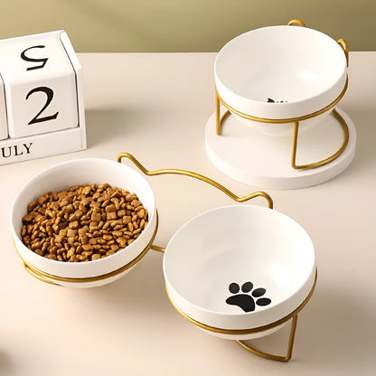 White ceramic pet bowl with cat paw print in a black iron stand with cat ear details