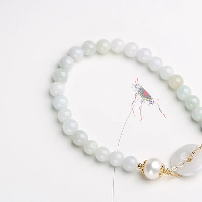 Natural jade bracelet with a geometric peace buckle clasp and round pendant.