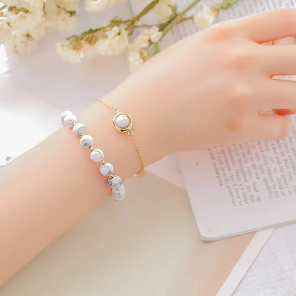 Double-layer women's bracelet with lucky beads and colourful crystals in gold-toned setting