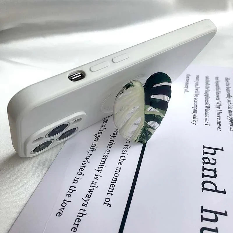 Stylish smartphone stand with leaf-inspired design for secure hands-free support and mobile device versatility