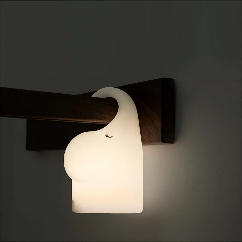 White elephant-shaped night light with silicone texture, 96mm wide by 151mm tall, emitting warm white glow