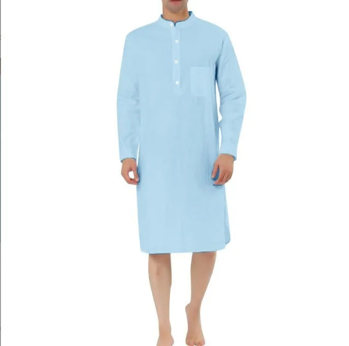 Man wearing a dark blue cotton shirt robe with button front, long sleeves, and side pockets.
