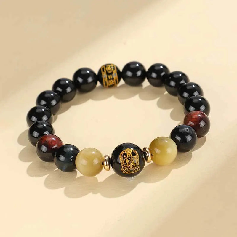 Handcrafted black agate and tiger eye stone beaded bracelet with a central carved zodiac deity charm.