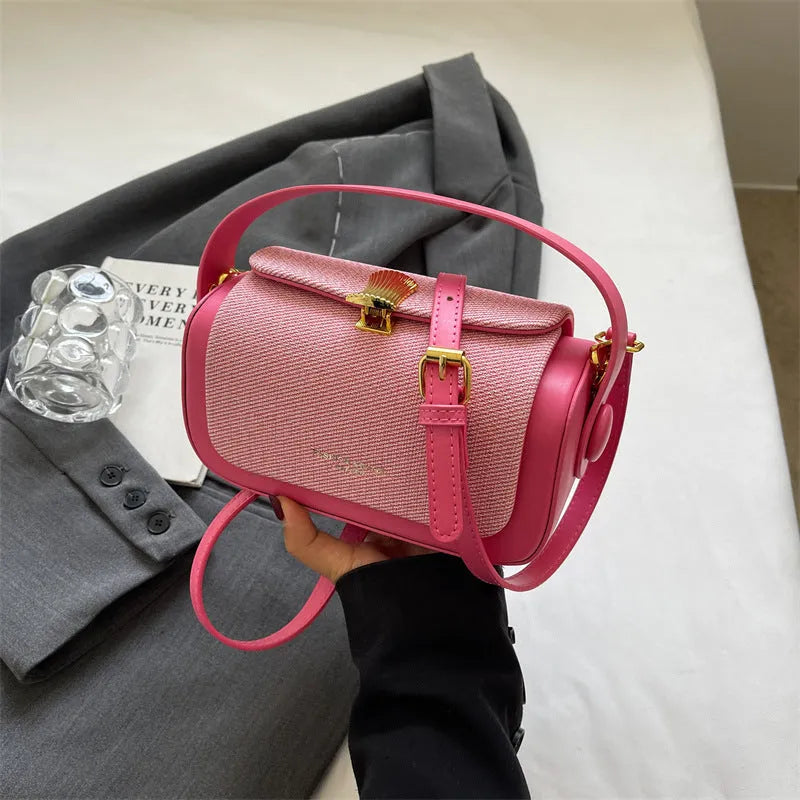 Women's PU leather messenger bag in a horizontal square shape with a lock and adjustable shoulder strap.