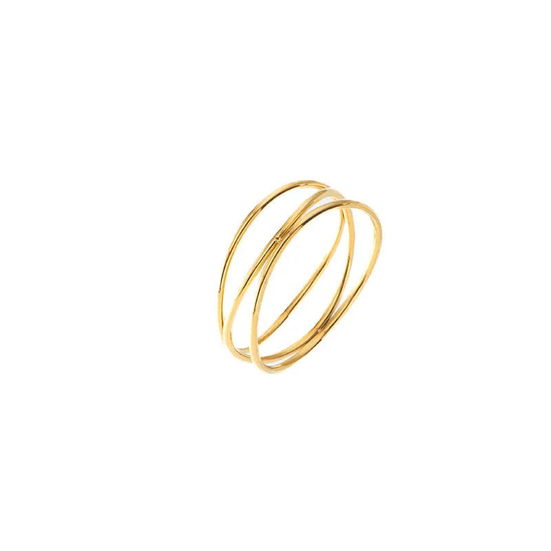 Gold titanium steel geometric coil ring with three-layer design on a model's finger.