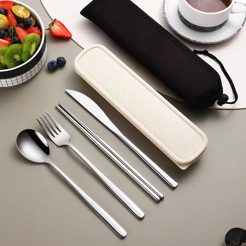 Gold and black stainless steel knife fork spoon set inside a grey mesh carrying bag.
