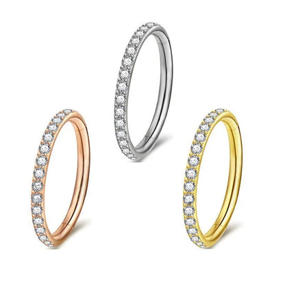 A seamless round hoop nose ring in stainless steel, shown alongside gold and rose gold colour options.