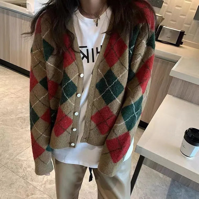 Long sleeve knitted cardigan in a light khaki colour, shown open over a white top, demonstrating its relaxed fit and medium weight.