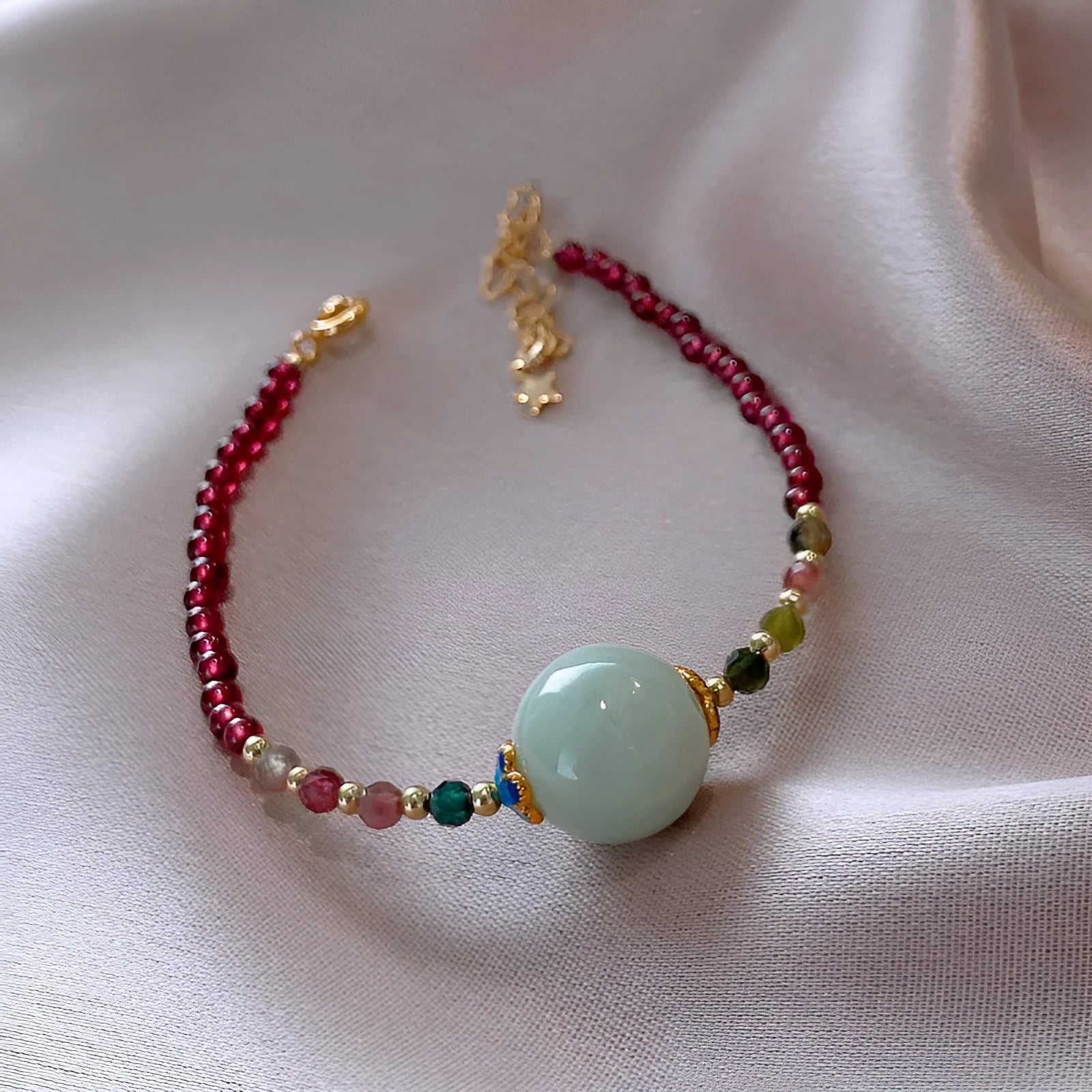 Women's garnet bracelet with aquamarine tourmaline drop charm and electroplated finish