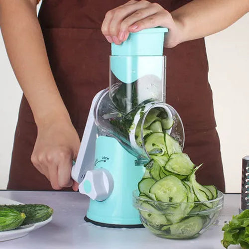 Blue multifunctional round mandoline vegetable slicer and cheese grater with stainless steel blades on a kitchen counter.