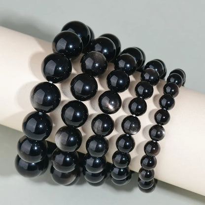 Hand-woven obsidian crystal bracelet showing round beads with ethnic styling in multiple colour options