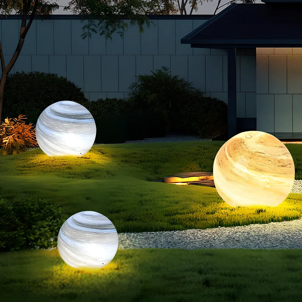 Solar lawn lamp in garden setting showing waterproof construction and LED illumination