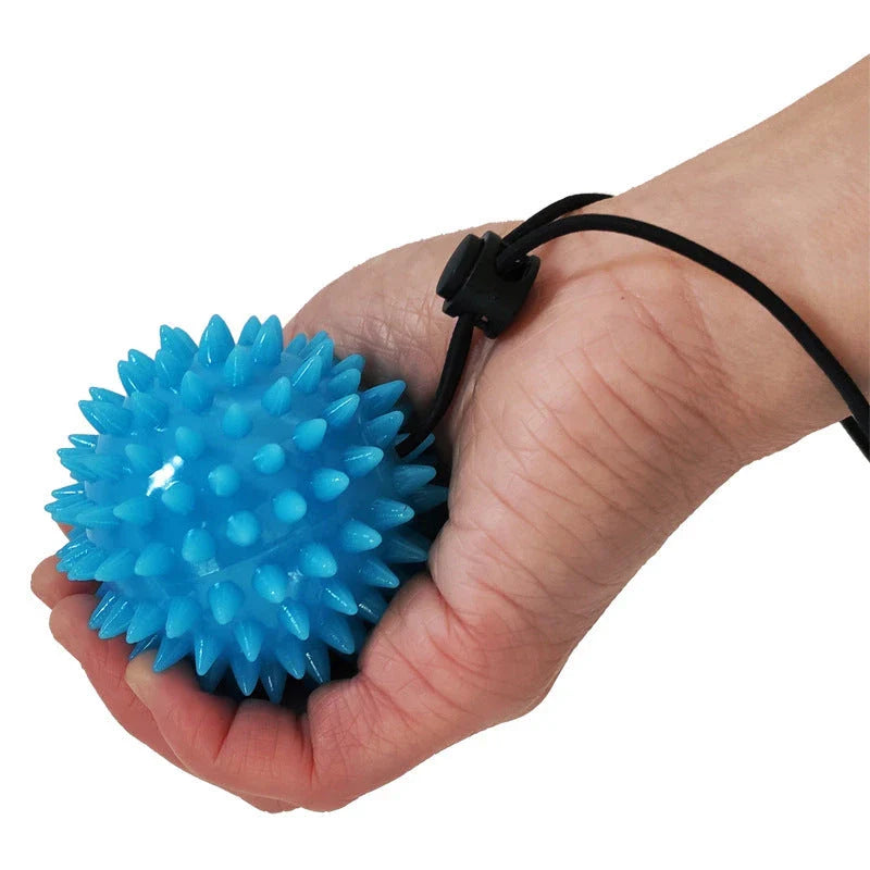 Therapeutic hand grip massager with massage bumps and finger holes for improving grip strength and relaxing hand muscles
