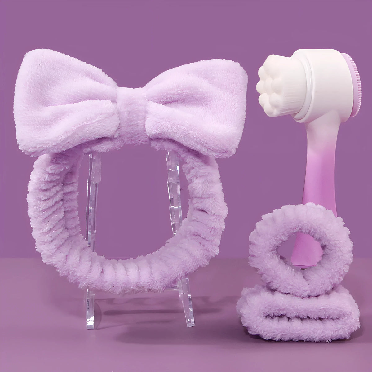 Facial brush set with coral fleece hair band and four nylon-bristle brushes in purple, grey, white, or pink colours